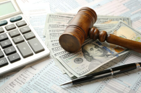 image of gavel over cash with calculator