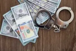 handcuffs on top of money