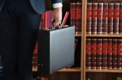 image of man with briefcase in library