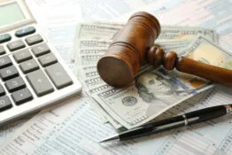 image of gavel over cash with calculator