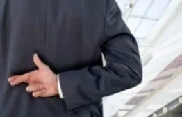 image of crossed finger behind back