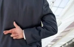 image of crossed finger behind back