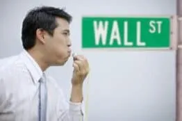 person blowing whistle on Wall Street